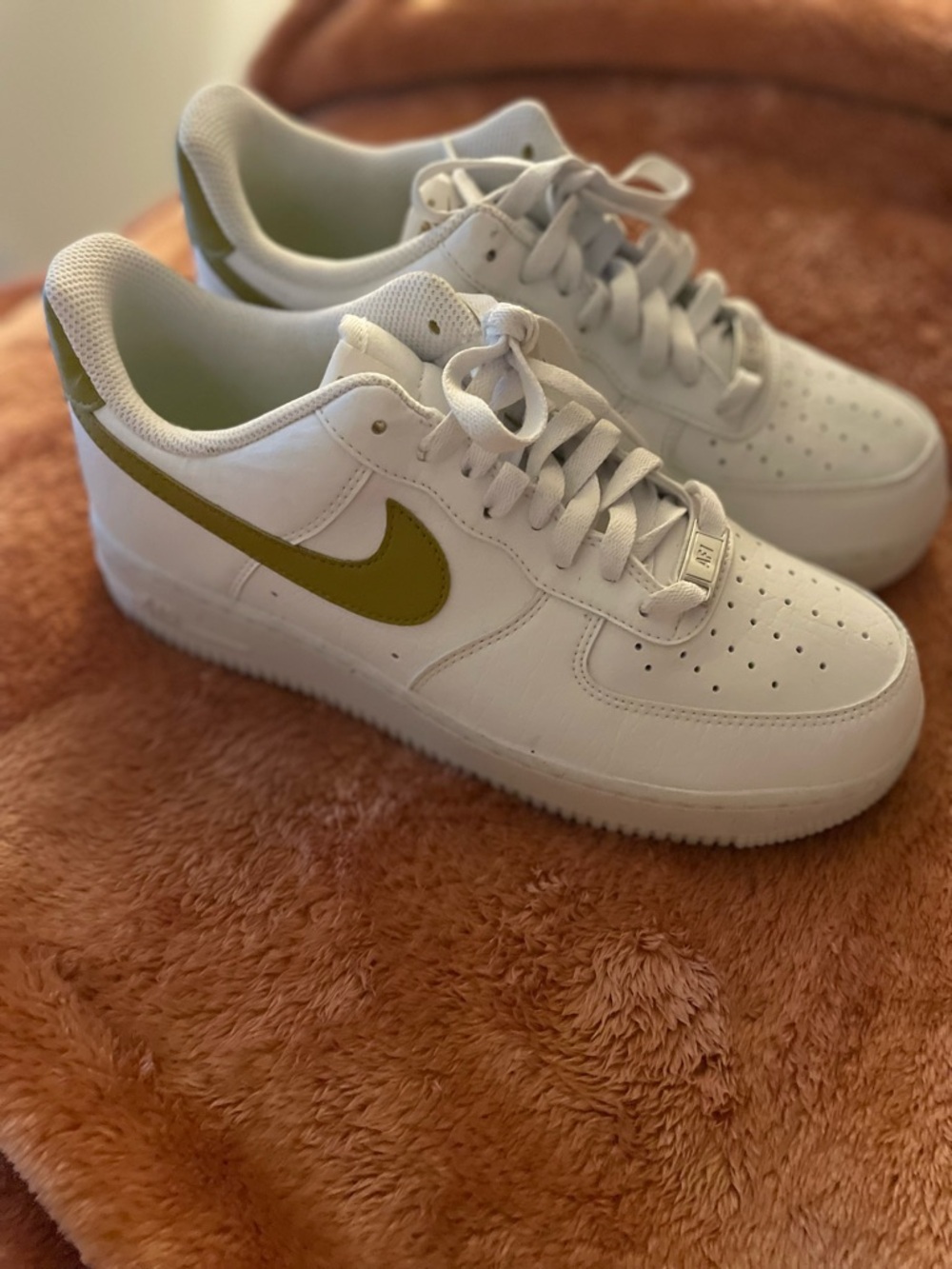 Nike White Low-Top Sneakers with Gold Swoosh